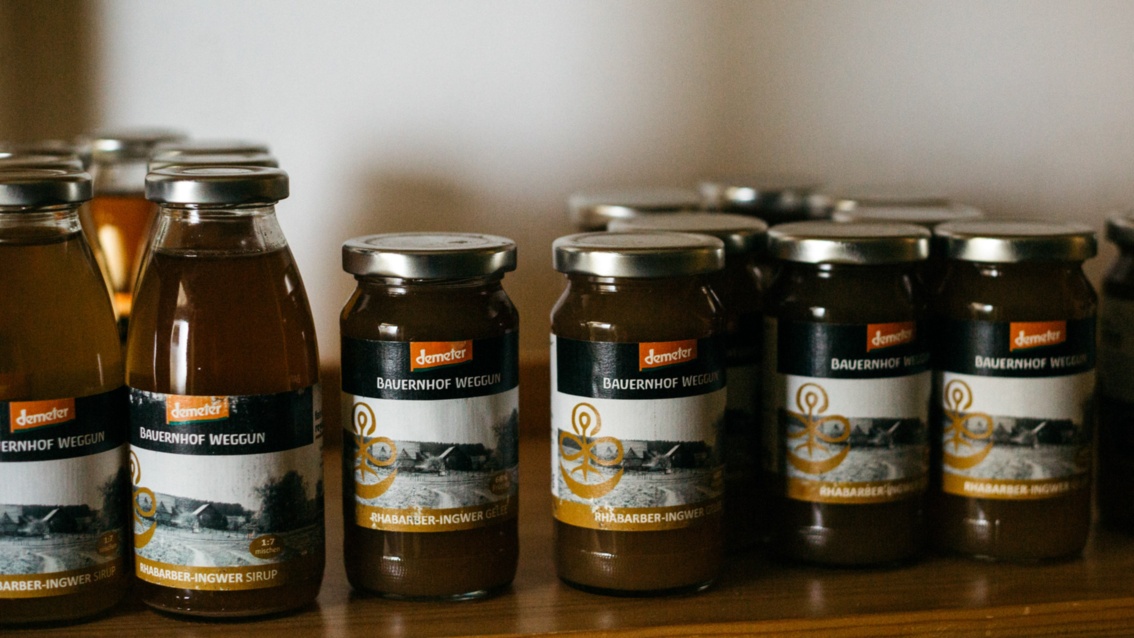 Eine Reihe von Marmeladengläsern mit dem Markenzeichen von Demeter oben auf dem Etikett.