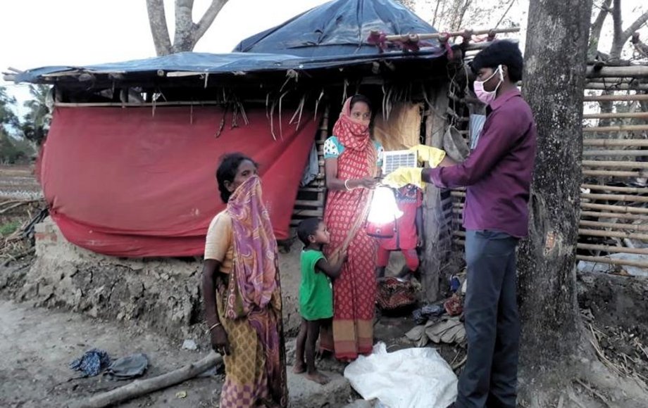 Frauen bekommen Solarlampen überreicht.