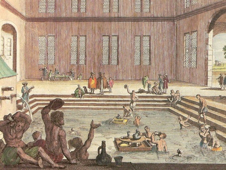 Ein Kupferstich zeigt das Innere des Kaiserbades; Badende übergießen sich mit Thermalwassser und trinken davon.