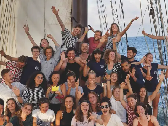 Gruppenfoto von jungen Menschen auf einem großen Segelboot