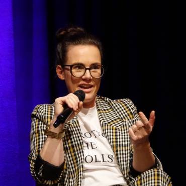 Aktivistin Katja Diehl auf einer Bühne mit Mikrofon