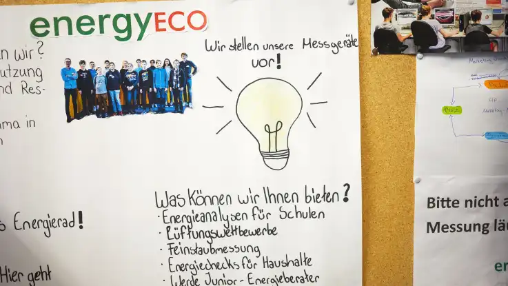 Auf einem hangeschriebenen Aushang informieren die Schüler über ihren Aktivitäten. Eine gemalte Glühbirne schafft zusätzlich für Aufmerksamkeit.